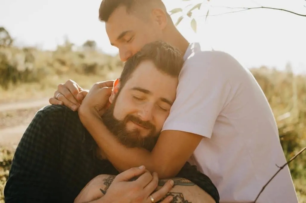 Gay couple in love sharing a big hug